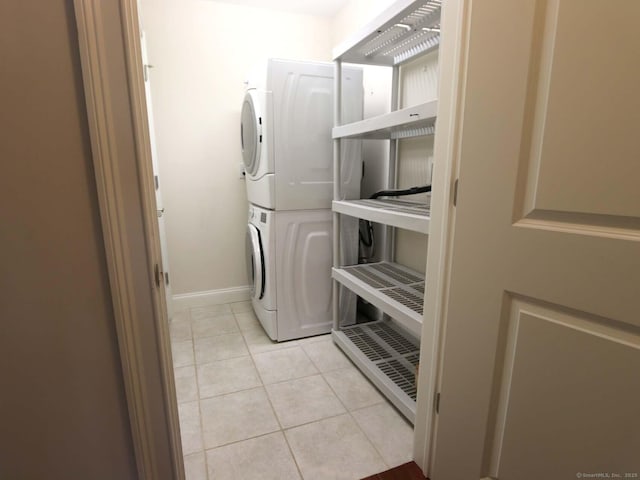 144 E Ave Apt B106, Norwalk, CT 06851 - washroom featuring stacked washer / dryer, light tile patterned floors, and baseboards