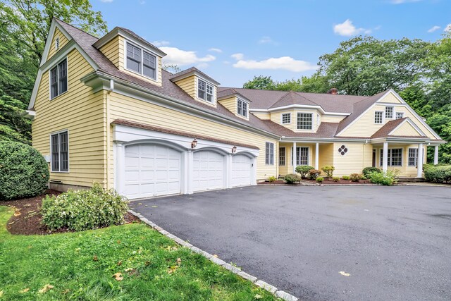 4 Lyons Plain Rd, Weston, CT 06883 - shingle-style home featuring asphalt driveway, an attached garage, and a porch
