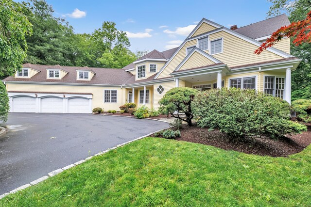 4 Lyons Plain Rd, Weston, CT 06883 - view of front of home with asphalt driveway, an attached garage, and a shingled roof