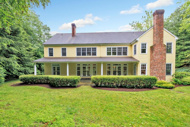 4 Lyons Plain Rd, Weston, CT 06883 - rear view of property featuring a chimney, french doors, and a lawn