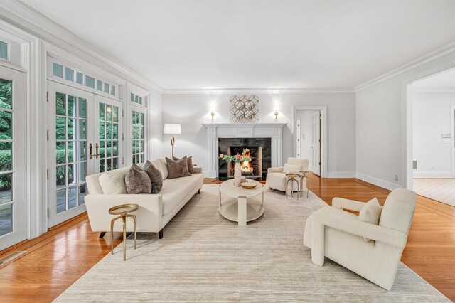 4 Lyons Plain Rd, Weston, CT 06883 - living room featuring crown molding, french doors, a fireplace, and wood finished floors