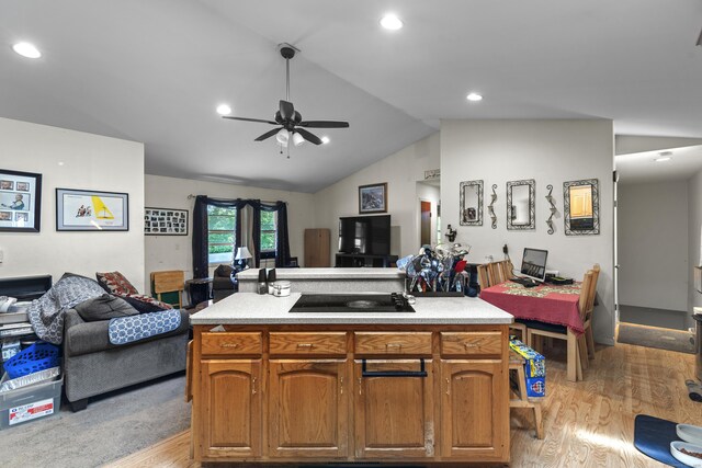 337 Woodbine Rd, Stamford, CT 06903 - kitchen with open floor plan, light wood finished floors, lofted ceiling, a ceiling fan, and light countertops