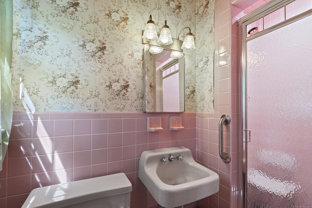 337 Woodbine Rd, Stamford, CT 06903 - bathroom featuring wallpapered walls, a stall shower, toilet, a wainscoted wall, and a sink