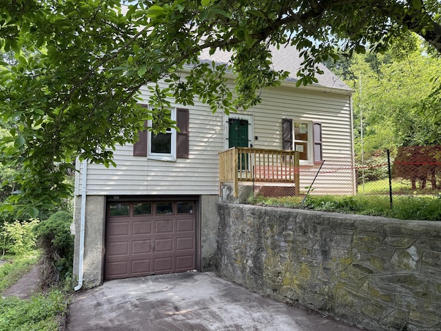 34 Buckingham Ave, Norwich, CT 06360 - view of front of house with an attached garage, concrete driveway, and a shingled roof