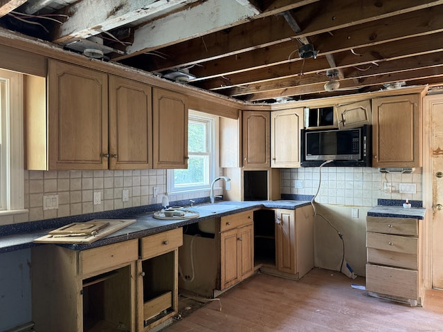 34 Buckingham Ave, Norwich, CT 06360 - kitchen featuring stainless steel microwave, a sink, tasteful backsplash, and light wood finished floors