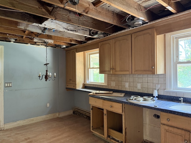 34 Buckingham Ave, Norwich, CT 06360 - kitchen with dark countertops, light wood-style floors, backsplash, pendant lighting, and baseboards