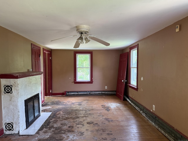 34 Buckingham Ave, Norwich, CT 06360 - unfurnished living room with a ceiling fan, a tiled fireplace, and baseboards