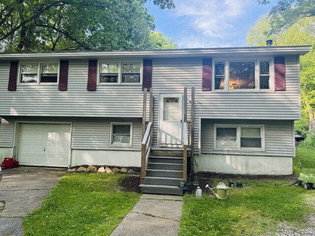 79 Black Hill Rd, Plainfield, CT 06374 - split foyer home with an attached garage, entry steps, driveway, and a front lawn