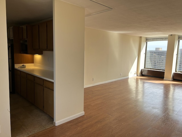 1 Gold St Apt 21G, Hartford, CT 06103 - kitchen featuring baseboards, light countertops, and dark brown cabinets
