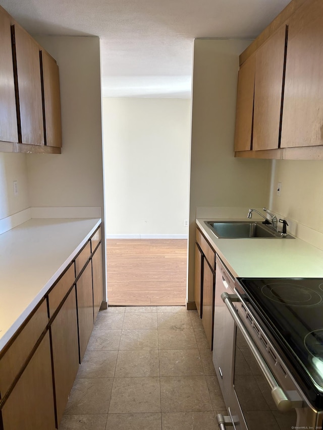 1 Gold St Apt 21G, Hartford, CT 06103 - kitchen with a sink, light countertops, stainless steel range with electric cooktop, and baseboards