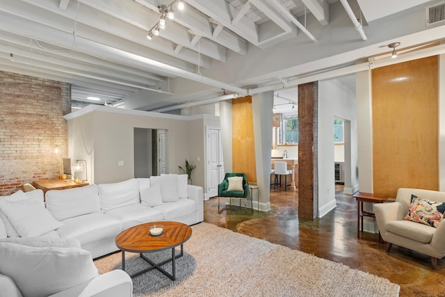 43 Chestnut St Unit 60, New Haven, CT 06511 - living area featuring finished concrete floors, brick wall, beam ceiling, and baseboards