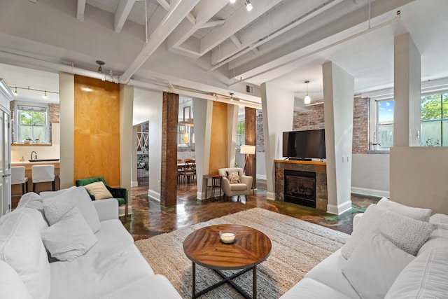 43 Chestnut St Unit 60, New Haven, CT 06511 - living area featuring track lighting, baseboards, beamed ceiling, and healthy amount of natural light