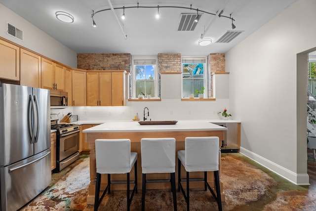 43 Chestnut St Unit 60, New Haven, CT 06511 - kitchen with appliances with stainless steel finishes, backsplash, a center island, and light countertops