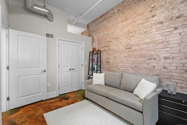 43 Chestnut St Unit 60, New Haven, CT 06511 - living room with concrete flooring, brick wall, and a high ceiling