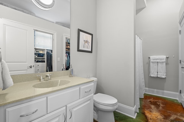 43 Chestnut St Unit 60, New Haven, CT 06511 - full bathroom featuring baseboards, vanity, a spacious closet, toilet, and concrete flooring