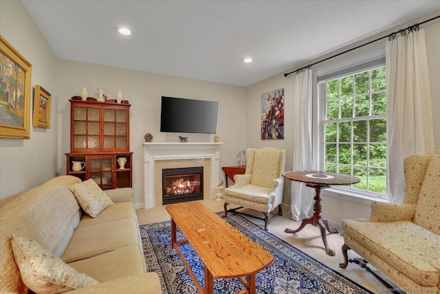 19 Oak Leaf Cir, Coventry, CT 06238 - living area featuring healthy amount of natural light, a glass covered fireplace, recessed lighting, and baseboards