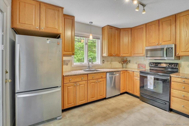 19 Oak Leaf Cir, Coventry, CT 06238 - kitchen featuring appliances with stainless steel finishes, a sink, decorative backsplash, light stone counters, and decorative light fixtures