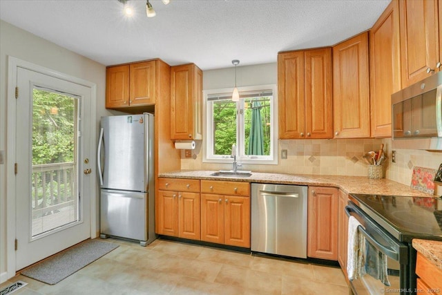 19 Oak Leaf Cir, Coventry, CT 06238 - kitchen featuring stainless steel appliances, a sink, decorative backsplash, pendant lighting, and light stone counters