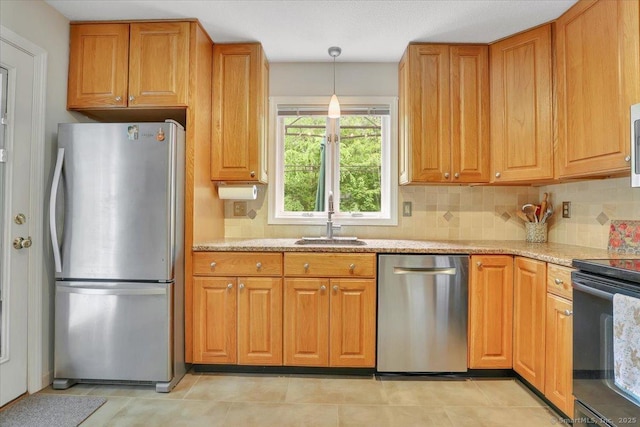 19 Oak Leaf Cir, Coventry, CT 06238 - kitchen with stainless steel appliances, a sink, decorative backsplash, light stone counters, and hanging light fixtures