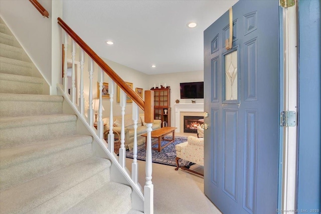 19 Oak Leaf Cir, Coventry, CT 06238 - carpeted entryway featuring stairway, recessed lighting, and a lit fireplace