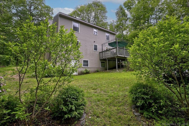 19 Oak Leaf Cir, Coventry, CT 06238 - rear view of house featuring a wooden deck and a lawn