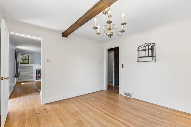 54 Briarwood Rd, Newington, CT 06111 - empty room featuring a chandelier, light wood finished floors, ornamental molding, beam ceiling, and a lit fireplace