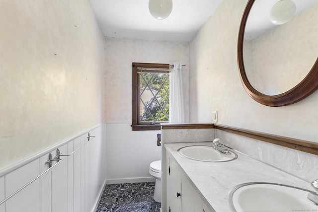 54 Briarwood Rd, Newington, CT 06111 - bathroom featuring toilet, double vanity, marble look tile flooring, and baseboards
