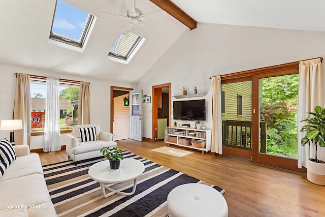 54 Briarwood Rd, Newington, CT 06111 - living area featuring wood finished floors, high vaulted ceiling, beam ceiling, a skylight, and ceiling fan