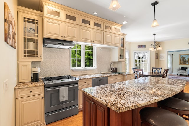 3 Autumn Ridge Rd, Newtown, CT 06470 - kitchen featuring stainless steel appliances, under cabinet range hood, a breakfast bar area, a sink, and light wood-style flooring