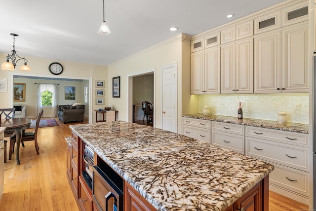 3 Autumn Ridge Rd, Newtown, CT 06470 - kitchen featuring a kitchen island, light stone countertops, cream cabinets, glass insert cabinets, and open floor plan