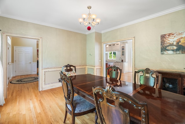 3 Autumn Ridge Rd, Newtown, CT 06470 - dining area with a chandelier, light wood-type flooring, crown molding, and a wainscoted wall