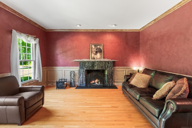 3 Autumn Ridge Rd, Newtown, CT 06470 - living room featuring light wood-style flooring, ornamental molding, a wainscoted wall, a fireplace, and a decorative wall