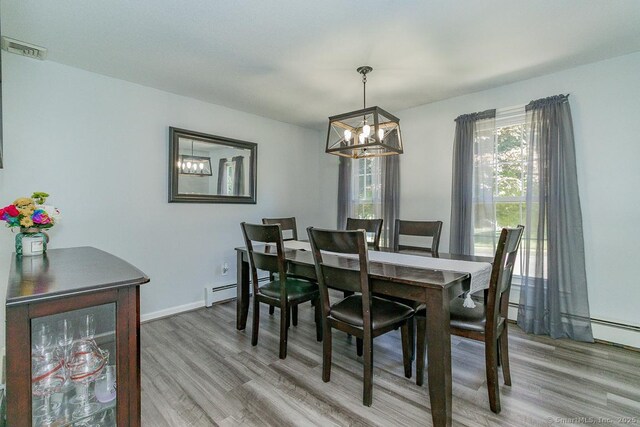 59 Valley Dr, Berlin, CT 06037 - dining space featuring a chandelier, wood finished floors, and baseboard heating