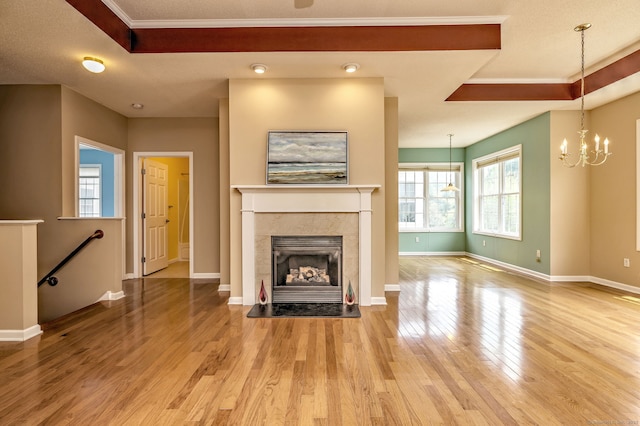 35 Todd St Unit 204, Hamden, CT 06518 - unfurnished living room featuring a raised ceiling, wood finished floors, plenty of natural light, and crown molding