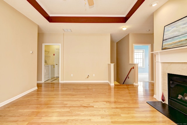 35 Todd St Unit 204, Hamden, CT 06518 - unfurnished living room with washer and clothes dryer, crown molding, a raised ceiling, light wood-style floors, and a high end fireplace