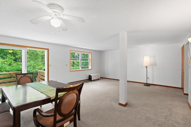 122 W Main St Apt E, Stafford, CT 06076 - dining space featuring light colored carpet, a baseboard heating unit, baseboards, and a ceiling fan