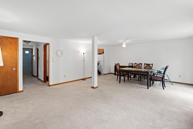 122 W Main St Apt E, Stafford, CT 06076 - dining space with light colored carpet, ceiling fan, and baseboards