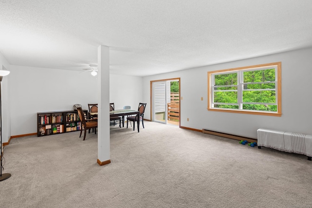 122 W Main St Apt E, Stafford, CT 06076 - dining area with carpet flooring, ceiling fan, baseboards, and a textured ceiling