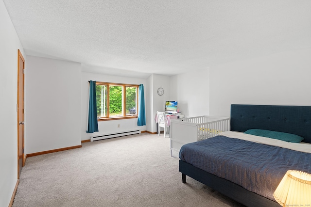 122 W Main St Apt E, Stafford, CT 06076 - carpeted bedroom featuring baseboard heating, a textured ceiling, and baseboards
