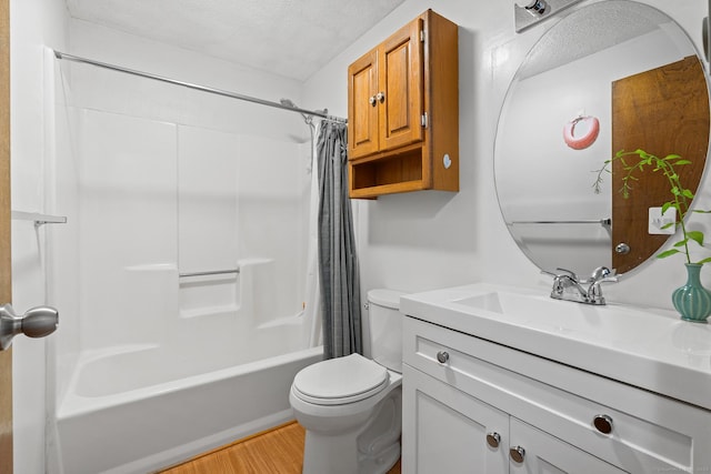 122 W Main St Apt E, Stafford, CT 06076 - bathroom featuring vanity, toilet, shower / bath combination with curtain, wood finished floors, and a textured ceiling