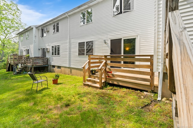 122 W Main St Apt E, Stafford, CT 06076 - rear view of house with a deck and a lawn