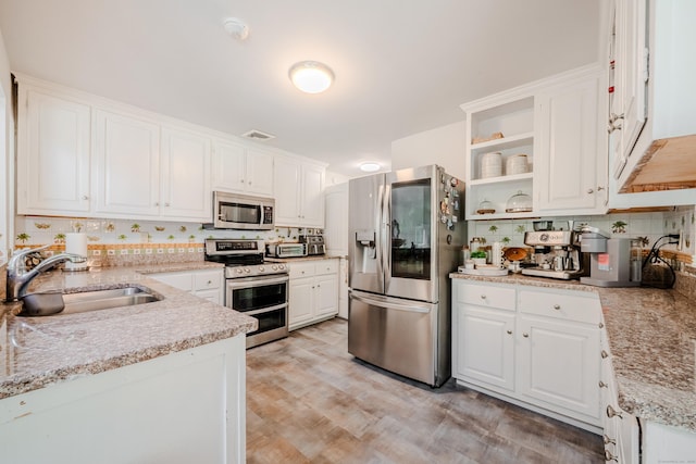 11 Walker Ln, Woodbridge, CT 06525 - kitchen featuring stainless steel appliances, a sink, white cabinets, open shelves, and backsplash
