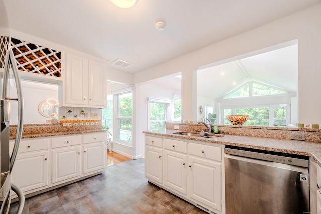 11 Walker Ln, Woodbridge, CT 06525 - kitchen featuring dishwasher, a sink, light wood-style flooring, white cabinetry, and vaulted ceiling