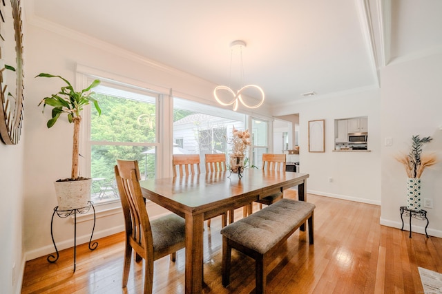 11 Walker Ln, Woodbridge, CT 06525 - dining area featuring crown molding, light wood finished floors, healthy amount of natural light, a chandelier, and baseboards