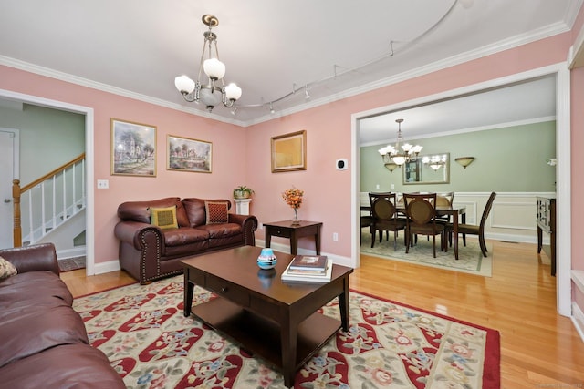15 Oakledge Cir, Norwalk, CT 06854 - living area featuring a chandelier, rail lighting, light wood-type flooring, ornamental molding, and stairway