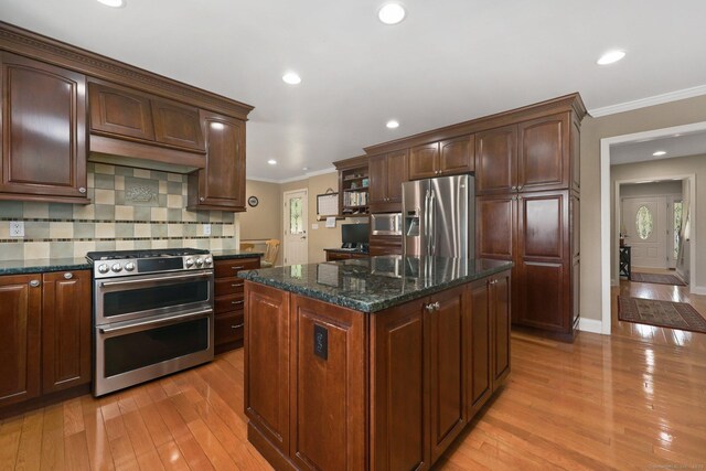 15 Oakledge Cir, Norwalk, CT 06854 - kitchen featuring appliances with stainless steel finishes, crown molding, light wood finished floors, a center island, and backsplash