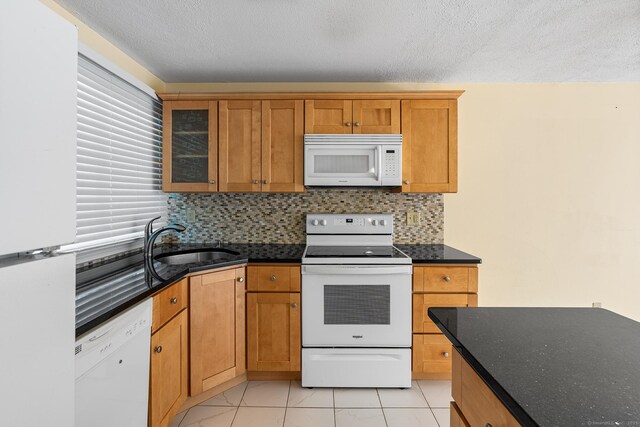 201 Baxter Rd Apt D, Mansfield, CT 06268 - kitchen featuring white appliances, a sink, decorative backsplash, brown cabinets, and glass insert cabinets