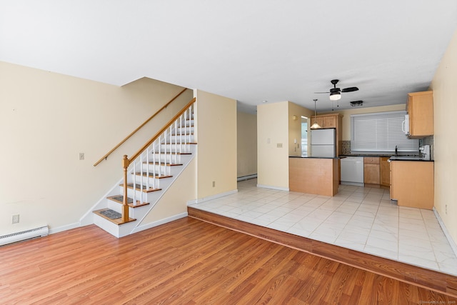 201 Baxter Rd Apt D, Mansfield, CT 06268 - unfurnished living room with light wood-style flooring, ceiling fan, stairway, baseboards, and a sink