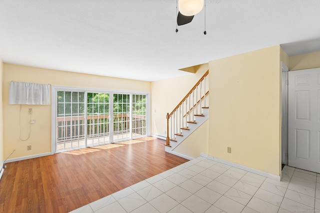 201 Baxter Rd Apt D, Mansfield, CT 06268 - entrance foyer featuring stairway, baseboards, a ceiling fan, and wood finished floors