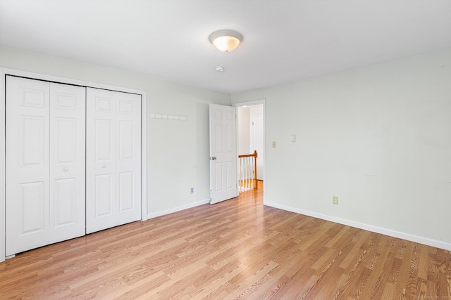 201 Baxter Rd Apt D, Mansfield, CT 06268 - unfurnished bedroom with light wood-style floors, baseboards, and a closet